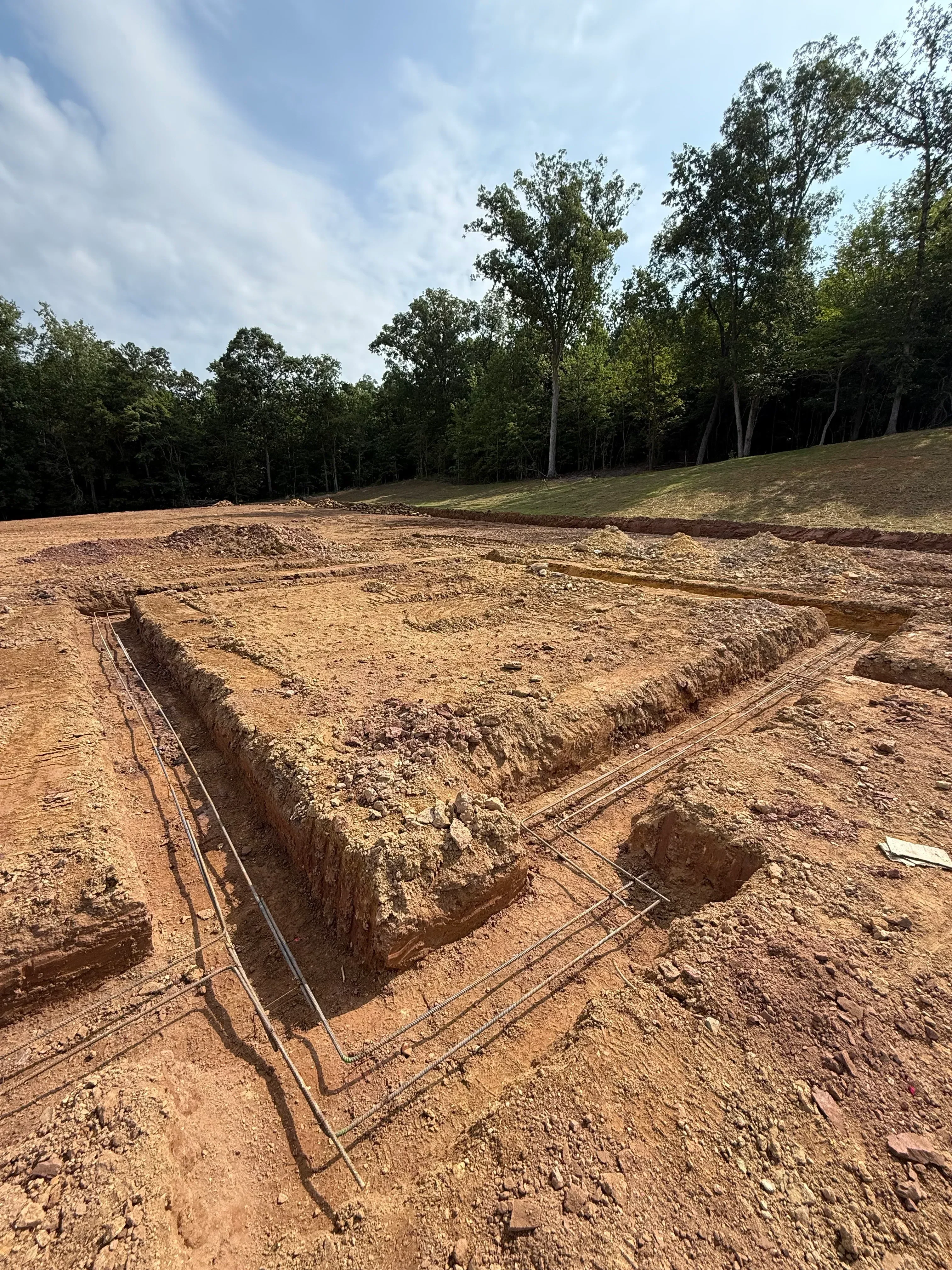 Excavated slope with geogrid reinforcement installed on compacted soil